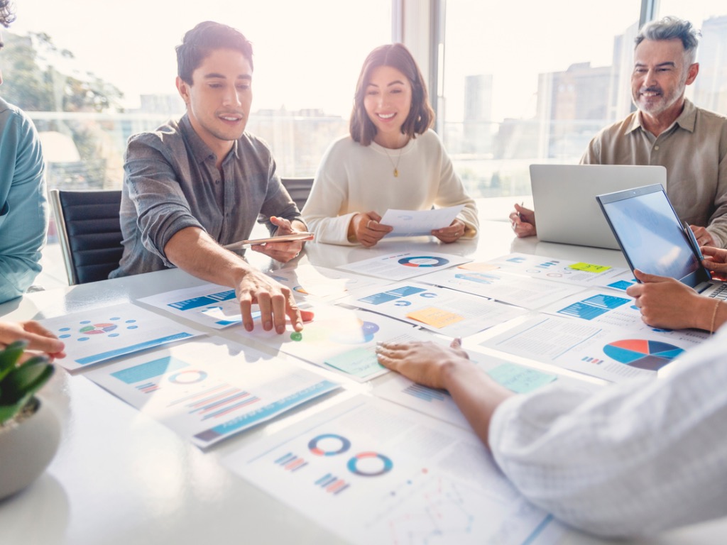 multi-racial-diverse-group-of-people-working-with-paperwork-on-a-board-room-table-at-a Building a Data-Driven Association That Engages Everyone