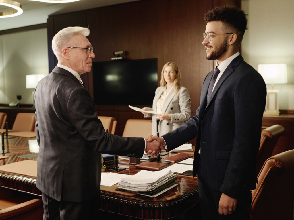 caucasian-and-middle-eastern-men-shaking-hands-standing-in-office-boardroom Bridging the Generational Gap: A Smarter Strategy for Associations